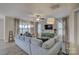 Living room with gray sectional sofa and access to porch at 517 Trillium Way, Belmont, NC 28012