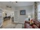 Home office with leather sofa and view into kitchen at 517 Trillium Way, Belmont, NC 28012