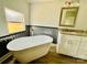 Modern bathroom with a large soaking tub and granite vanity at 568 Mahaffey Dr, Salisbury, NC 28146