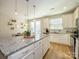 Bright kitchen with white cabinets, granite countertops, and stainless steel appliances at 810 Ayrshire Ave, Fort Mill, SC 29708