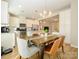 Well-lit kitchen and dining area, featuring stainless steel appliances and a wood dining table at 810 Ayrshire Ave, Fort Mill, SC 29708