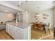 Open concept kitchen and dining area with granite island, white cabinets, and hardwood floors at 810 Ayrshire Ave, Fort Mill, SC 29708