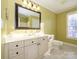 Bathroom with single vanity, mirror, and window at 9182 Bonnie Briar Cir, Charlotte, NC 28277