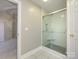 Updated bathroom with a walk-in shower and mosaic tile floor at 9182 Bonnie Briar Cir, Charlotte, NC 28277