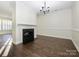 Dining room featuring hardwood floors, fireplace and chandelier at 9182 Bonnie Briar Cir, Charlotte, NC 28277