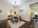 Bright dining room with chandelier, seating for four, and connecting kitchen at 9182 Bonnie Briar Cir, Charlotte, NC 28277