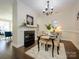 Dining area with fireplace, chandelier, and seating for four, perfect for gatherings at 9182 Bonnie Briar Cir, Charlotte, NC 28277