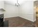 Hardwood floors and a chandelier highlight this dining room at 9182 Bonnie Briar Cir, Charlotte, NC 28277