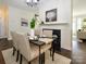 Inviting dining area with a fireplace, seating for four, and a cozy ambiance at 9182 Bonnie Briar Cir, Charlotte, NC 28277