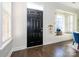 Welcoming entrance with hardwood floors and a black front door featuring transom window at 9182 Bonnie Briar Cir, Charlotte, NC 28277