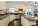 Well-equipped kitchen with stainless appliances, tile backsplash, and dark hardwood flooring at 9182 Bonnie Briar Cir, Charlotte, NC 28277