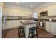 Well-lit kitchen with stainless steel appliances, white cabinets, and central island with seating at 9182 Bonnie Briar Cir, Charlotte, NC 28277