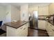 Spacious kitchen featuring stainless steel refrigerator, white cabinets, and center island with barstool seating at 9182 Bonnie Briar Cir, Charlotte, NC 28277