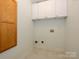 Small laundry room with washer/dryer hookups and upper cabinets at 9182 Bonnie Briar Cir, Charlotte, NC 28277