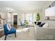 Bright living room featuring a bay window, stylish seating, and fresh neutral paint at 9182 Bonnie Briar Cir, Charlotte, NC 28277