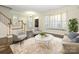 Spacious living room featuring hardwood floors, bay window, and fireplace at 9182 Bonnie Briar Cir, Charlotte, NC 28277