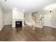 Living room with hardwood floors, fireplace and staircase at 9182 Bonnie Briar Cir, Charlotte, NC 28277