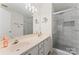 Modern bathroom with double vanity and a large walk-in shower at 9907 Reindeer Way Ln, Charlotte, NC 28216