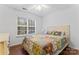 Charming bedroom with hardwood floors and a colorful bedspread at 9907 Reindeer Way Ln, Charlotte, NC 28216