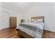 Spacious bedroom with wood flooring, a dresser and en-suite bathroom at 9907 Reindeer Way Ln, Charlotte, NC 28216