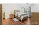 Cozy bedroom featuring wood flooring and a wood bed frame at 9907 Reindeer Way Ln, Charlotte, NC 28216