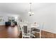 Bright dining room with hardwood floors and view into living room at 9907 Reindeer Way Ln, Charlotte, NC 28216