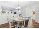 Charming dining room with white table and chairs, hardwood floors at 9907 Reindeer Way Ln, Charlotte, NC 28216