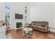 Bright living room with hardwood floors, fireplace, and comfortable seating at 9907 Reindeer Way Ln, Charlotte, NC 28216