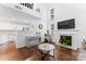 Two-story living room with fireplace and hardwood floors at 9907 Reindeer Way Ln, Charlotte, NC 28216