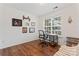 Home office with wood floors, desk, and comfortable seating at 9907 Reindeer Way Ln, Charlotte, NC 28216