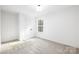 Bright bedroom with grey carpet and a window with natural light at 1013 Cathey Rd, Charlotte, NC 28214