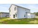 Two-story house with gray siding, a small yard, and a detached garage at 1013 Cathey Rd, Charlotte, NC 28214