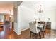 Formal dining room with chandelier, hardwood floors, and white wainscoting at 112 Marquette Dr, Mount Holly, NC 28120