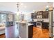 Modern kitchen with dark cabinets, granite countertops, and stainless steel appliances at 112 Marquette Dr, Mount Holly, NC 28120