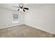 Well-lit bedroom with neutral carpeting and ceiling fan at 114 Ashbrook Dr, Fort Mill, SC 29715