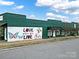 Green commercial building with a mural and street parking at 114 Ashbrook Dr, Fort Mill, SC 29715