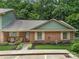 Brick ranch home with a green roof and landscaped yard at 114 Ashbrook Dr, Fort Mill, SC 29715