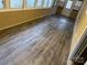 Sunroom with wood-look flooring and brick accent wall at 114 Ashbrook Dr, Fort Mill, SC 29715