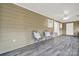 Bright sunroom features two wicker chairs, a side table, and wood-look flooring at 114 Ashbrook Dr, Fort Mill, SC 29715