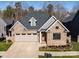 Aerial view of a charming craftsman style home with a two-car garage and manicured landscaping at 1422 Spring Ridge Ln, Denver, NC 28037