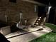 Night view of home's back exterior, including stairs, landscaping, and HVAC unit at 1422 Spring Ridge Ln, Denver, NC 28037