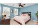 Serene bedroom with light blue walls, a ceiling fan, and plantation shutters at 14839 Rocky Top Dr, Huntersville, NC 28078