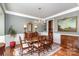 Formal dining room with hardwood floors, chandelier, and wainscoting at 14839 Rocky Top Dr, Huntersville, NC 28078