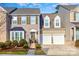 Tan two-story house with two-car garage and landscaped front yard at 14839 Rocky Top Dr, Huntersville, NC 28078