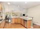 Kitchen island with granite countertop, stainless steel appliances, hardwood floors at 14839 Rocky Top Dr, Huntersville, NC 28078