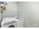 Convenient laundry room with washer, dryer, and ample shelf space at 14839 Rocky Top Dr, Huntersville, NC 28078