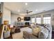 Spacious living room with a sectional sofa, fireplace, and large windows at 1968 Sapphire Meadow Dr, Fort Mill, SC 29715