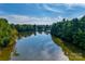 Aerial view of a tranquil lake surrounded by lush greenery at 2229 Iron Works Dr, Clover, SC 29710