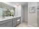 Double vanity bathroom with gray cabinets and a large mirror at 2547 Bullfrog Ln, Lancaster, SC 29720