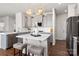 Bright kitchen with gray cabinets, white backsplash, and kitchen island at 2547 Bullfrog Ln, Lancaster, SC 29720